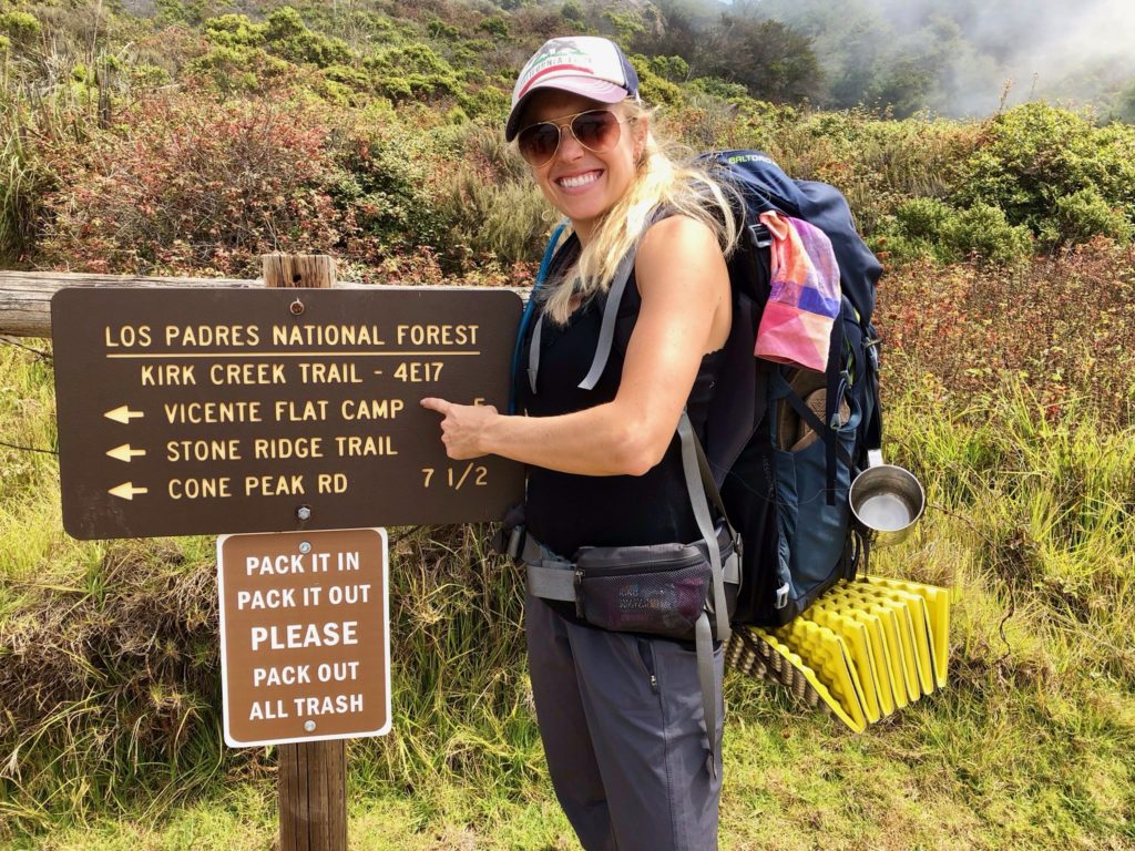Girl with her backpacking gear from a discounted outdoor gear website