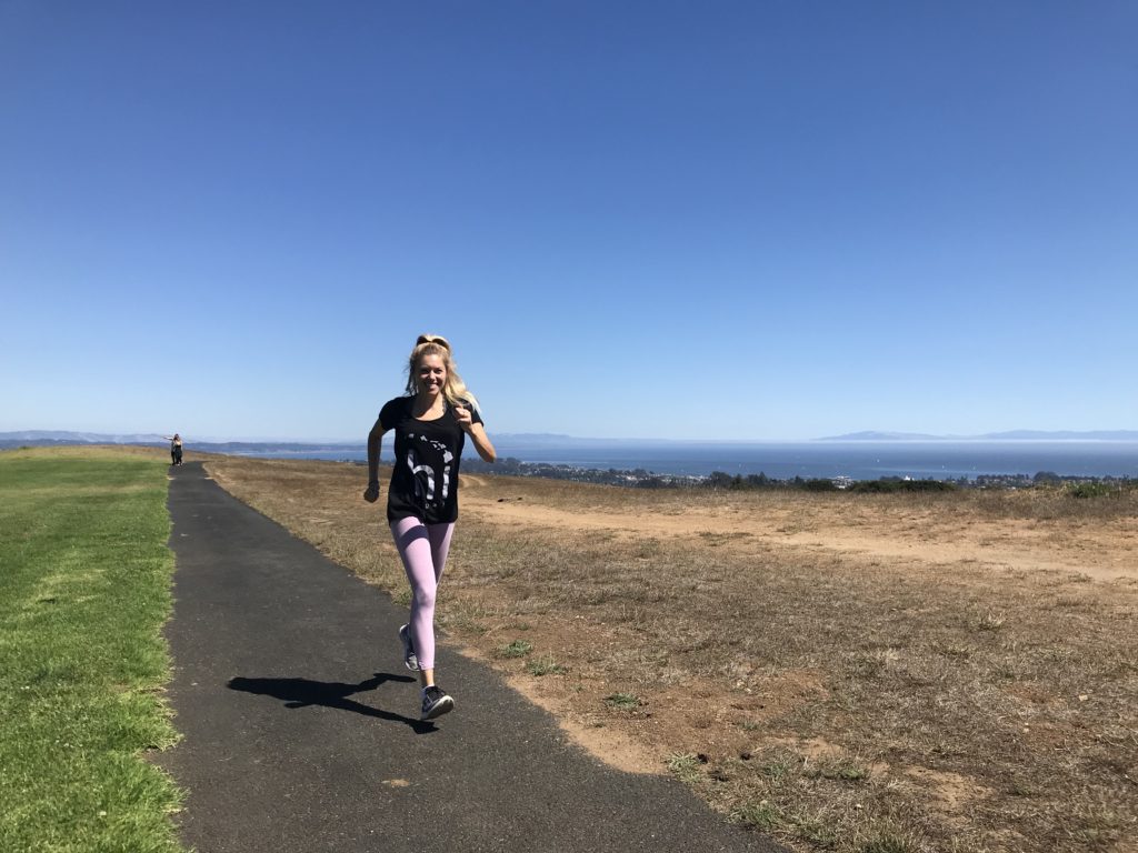 Girl on a run along the coast