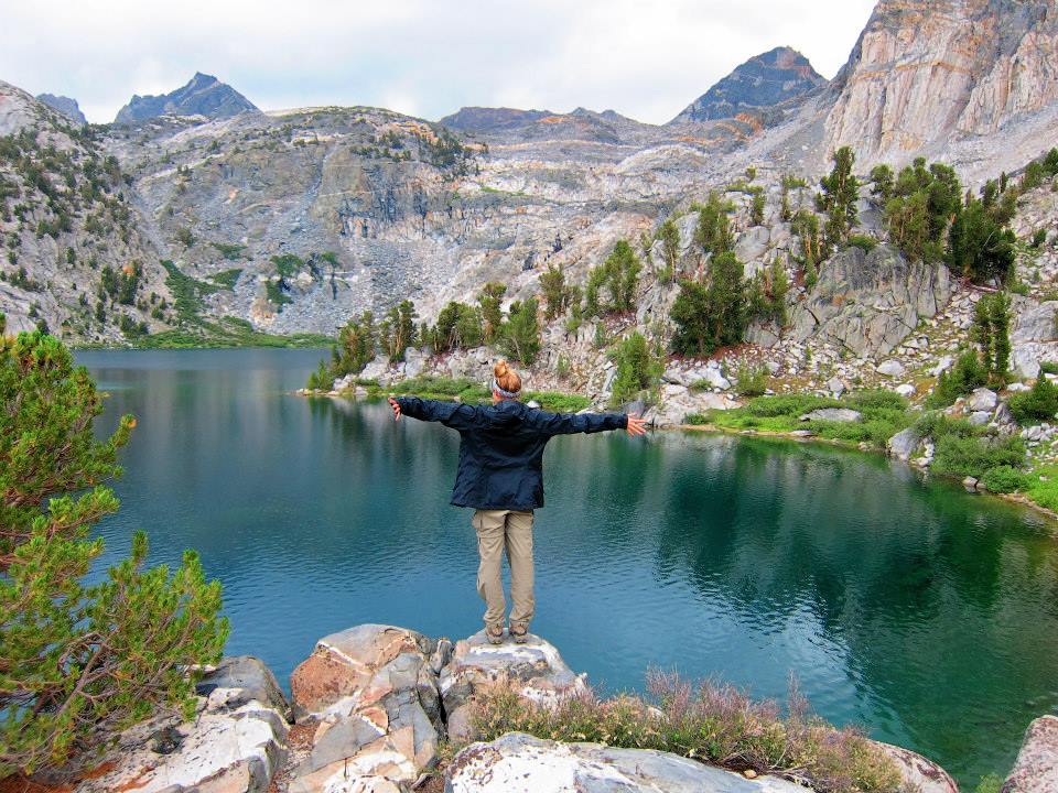 Chelsey Explores standing on a rock in front of the Rae Lakes in King's Canyon National Park