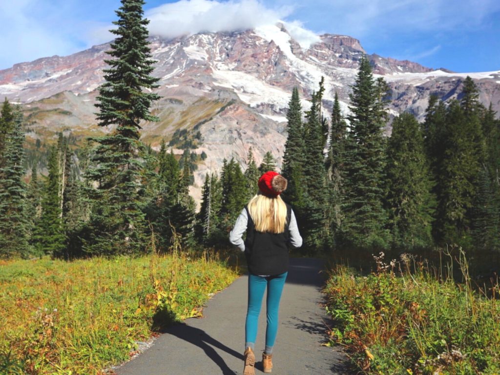 Girl wearing her hiking boots in front of Mt. Rainier