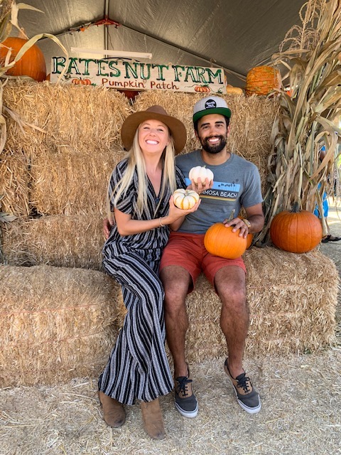 Chelsey and Dan holding pumpkins at Bates Nut Farm in San Diego