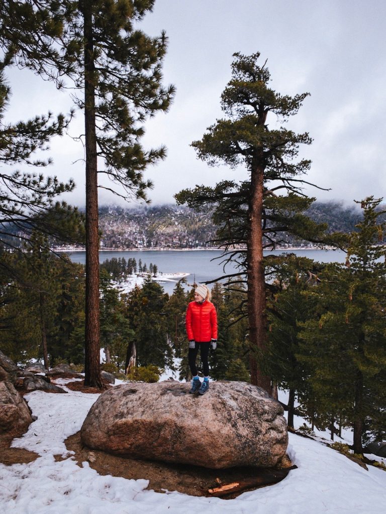 Girl hiking in Big Bear on a winter road trip from San Diego
