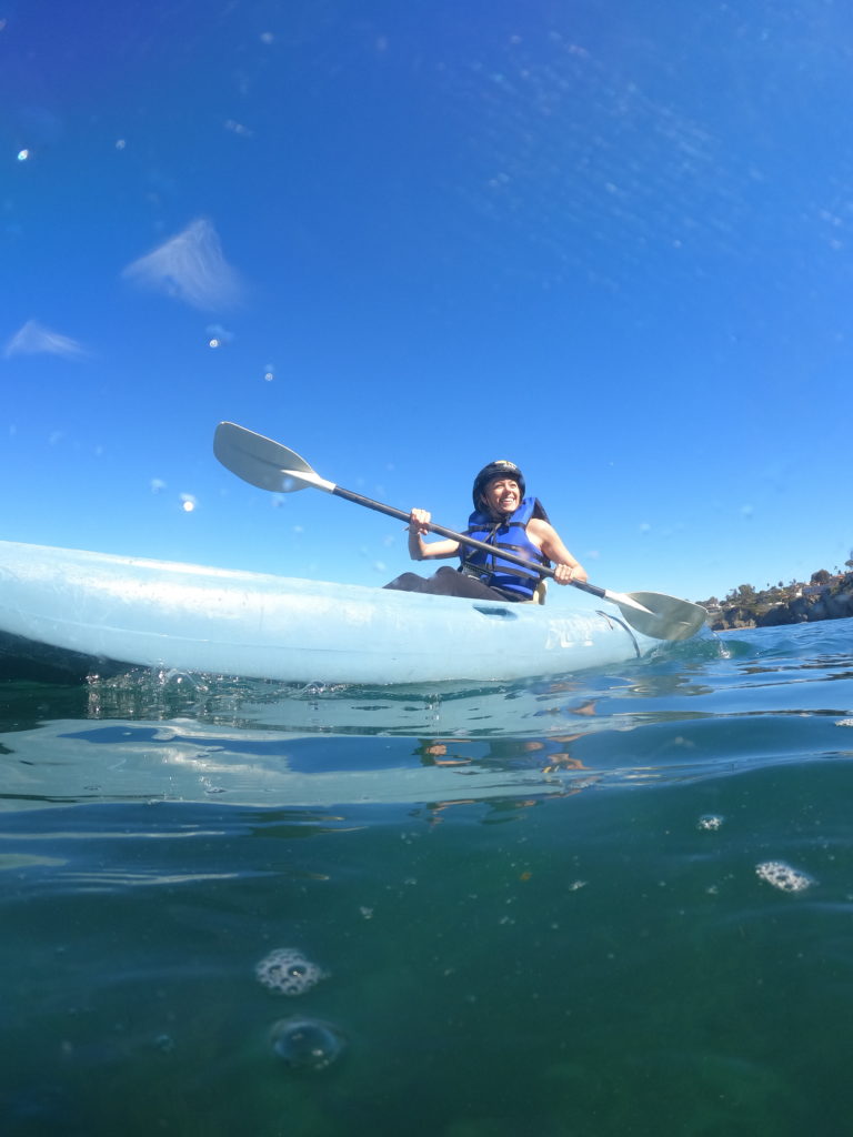 Girl Kayaking in La Jolla which is a must do activity as part of your San Diego itinerary