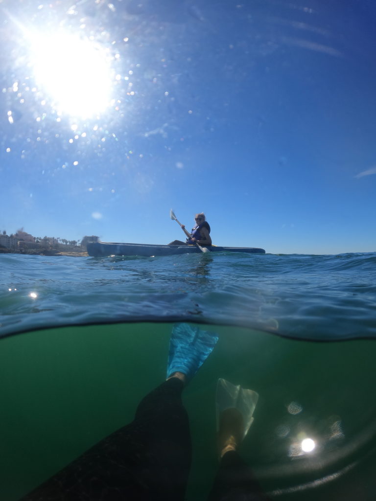 Girl kayaking in La Jolla which is a San Diego water sport