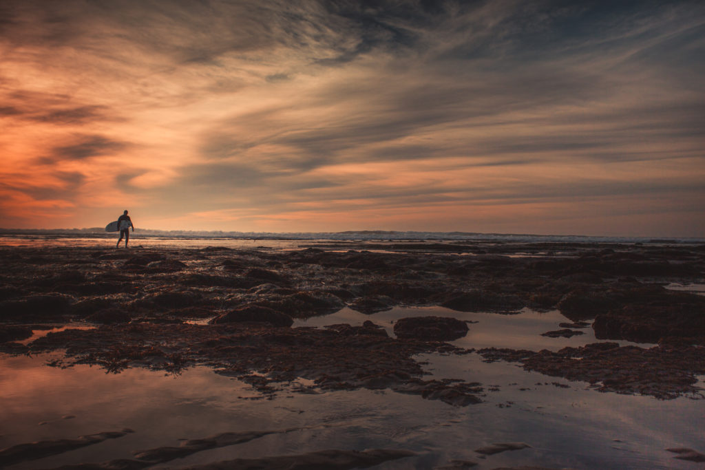 Sunset cliffs surfer at sunset