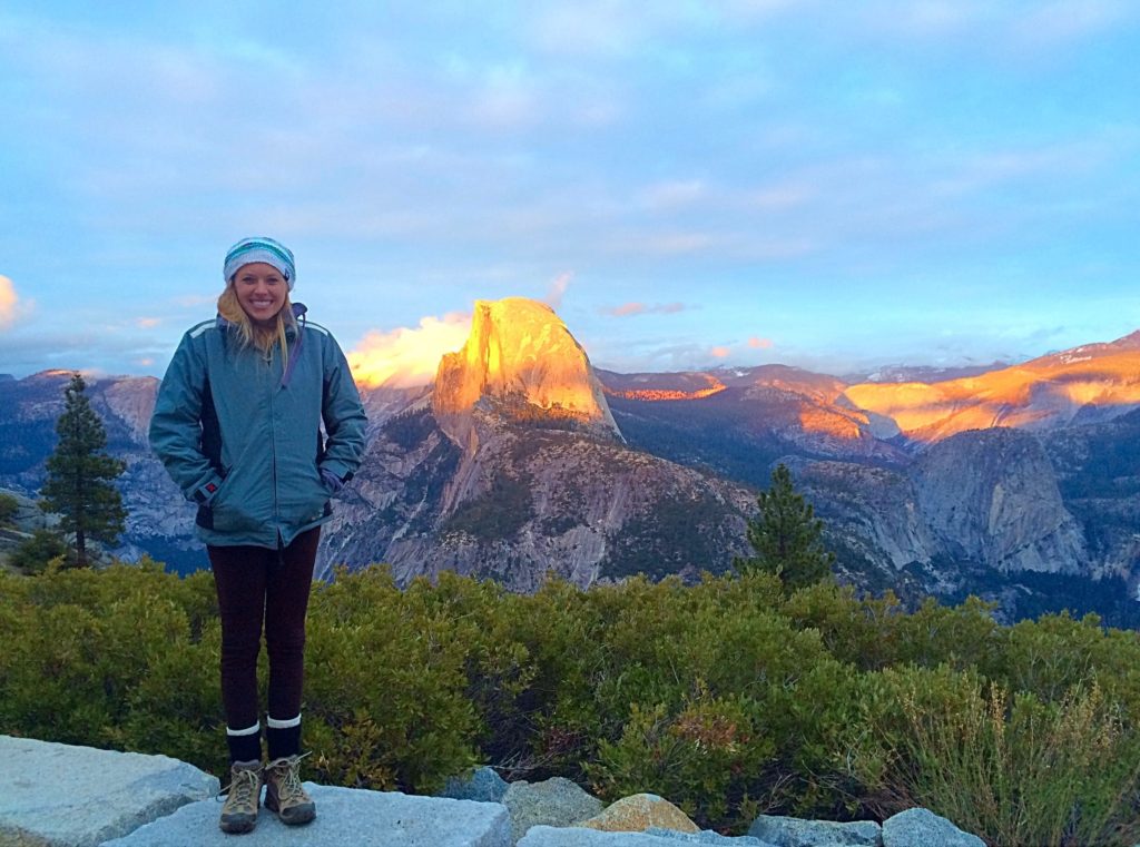 Yosemite National Park offers some of the best hikes near San Francisco. Here is a girl standing in front of halfdome at sunrise 