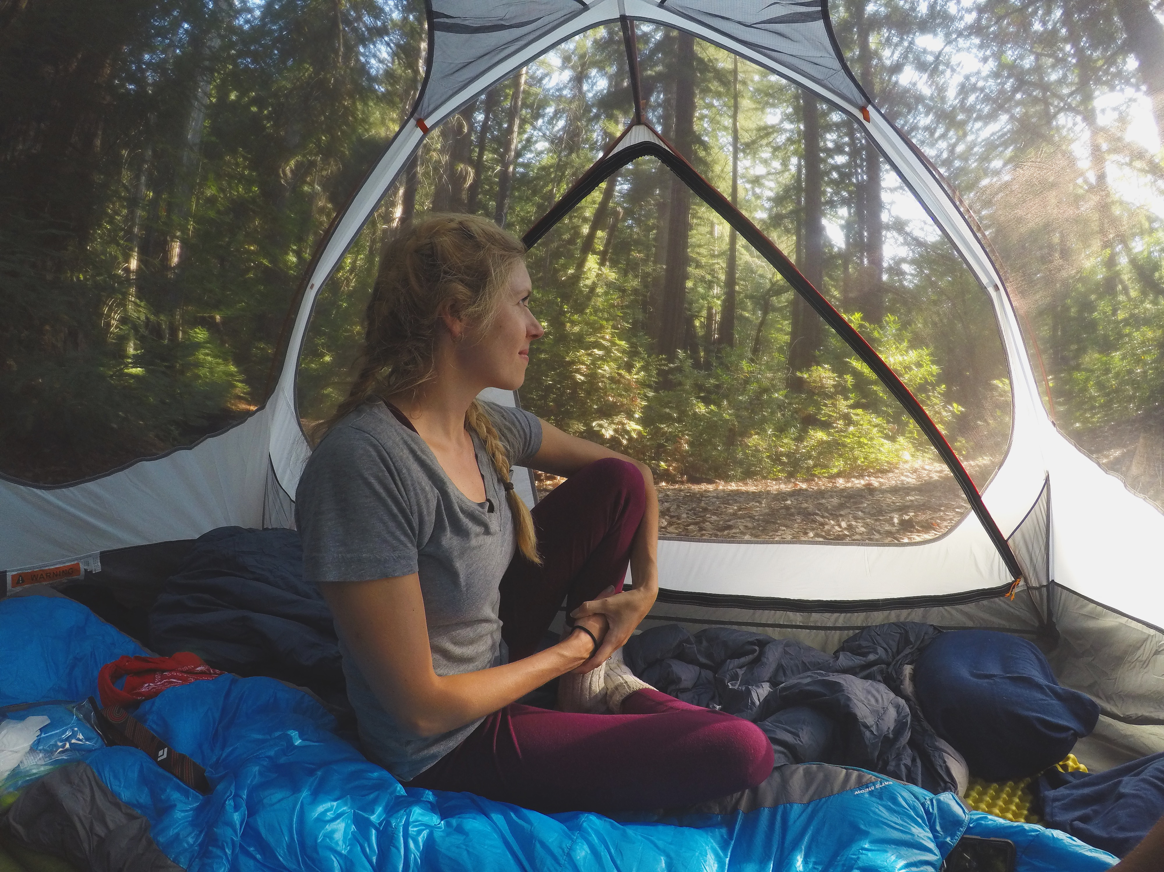 Chelsey Explores sitting in a tent looking out at the views