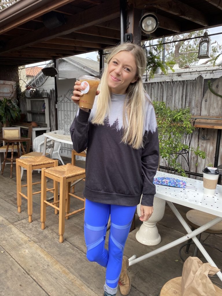 Chelsey holding a coffee at Garden Coffee: one of the best coffee shops in San Diego