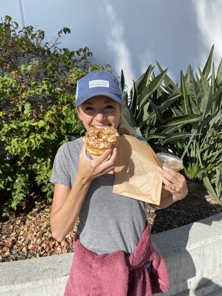 Chelsey eating a vegan donut from camp coffee in Oceanside