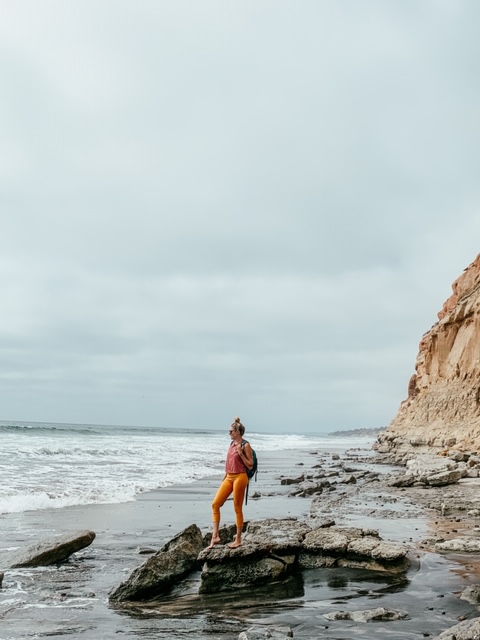 Girl standing on rock at Torrey Pines