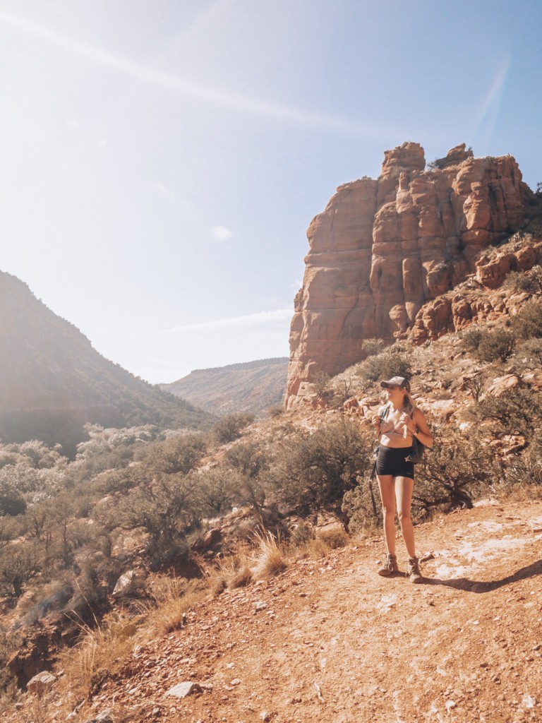 Girl hiking in the red rcoks as part of her sedona travel gudie