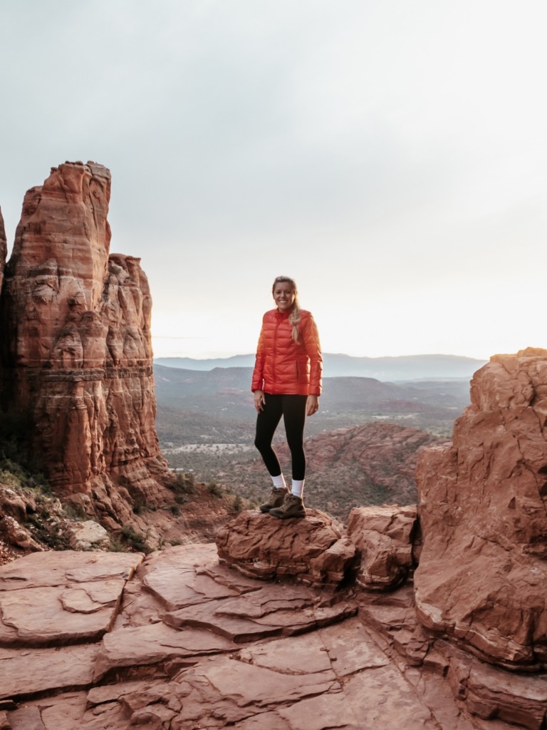 Girl standing at the top of Cathedral rock which is one of the best Sedona hiking trails