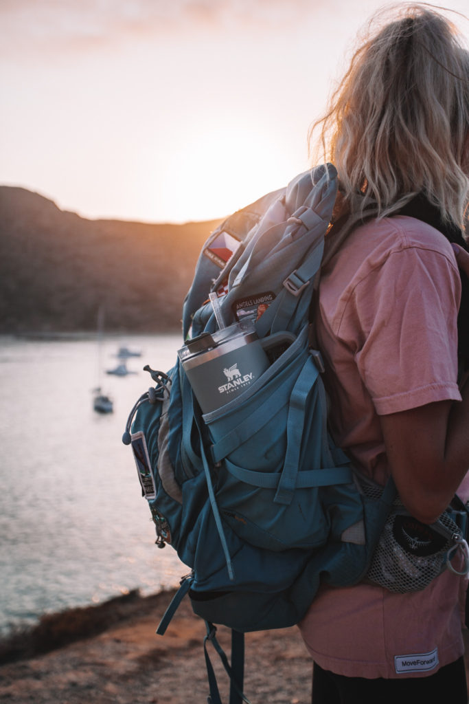 Girl with a backpacking backpack and her water bottle