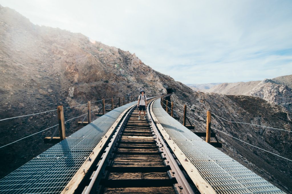 Man standing on the Goat trestle canyon which is a great hiking stop to make on your phoenix to san diego drive