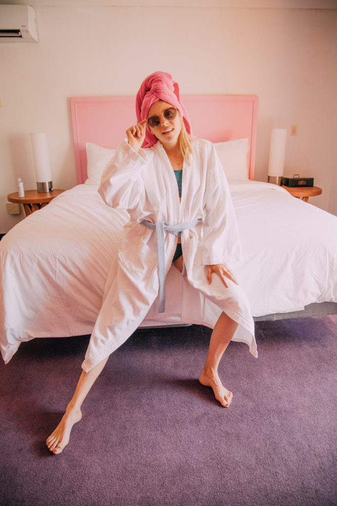 Girl sitting on bed in the Saguaro Hotel