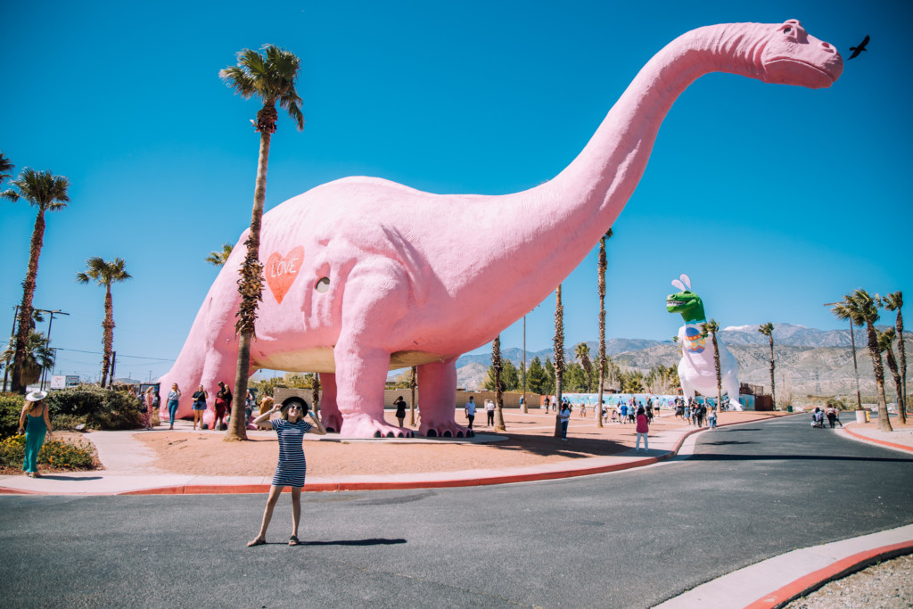 Girl standing in front of Cabazon Dinosaurs