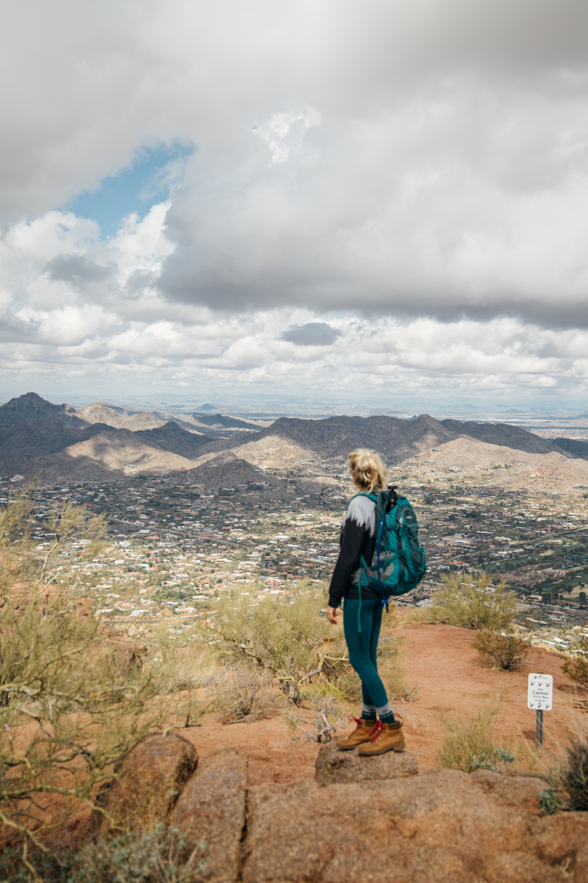 Girl standing looking at the views of Phoenix from atop Camelback mountain