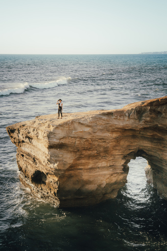 Girl standing on sunset cliffs which is an iconic stable of San Diego