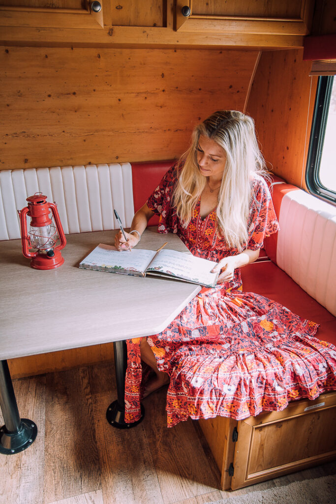 Chelsey signing a guest book in the trailer she stayed in near Joshua Tree