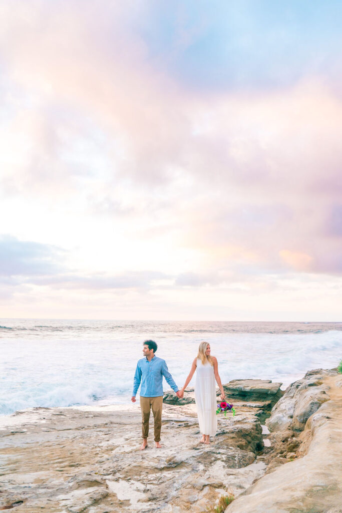 Couple walking on the shores of La Jolla during sunset