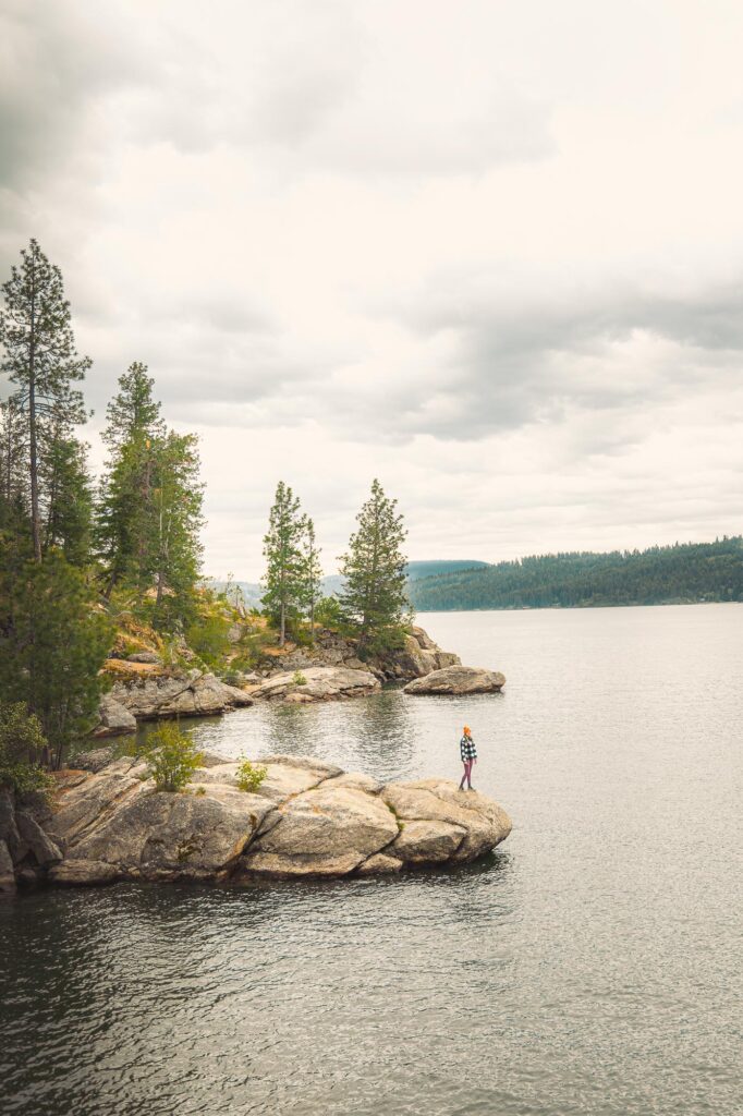 Girl standing on rock at Tubbs Hill in Coeur d’Alene