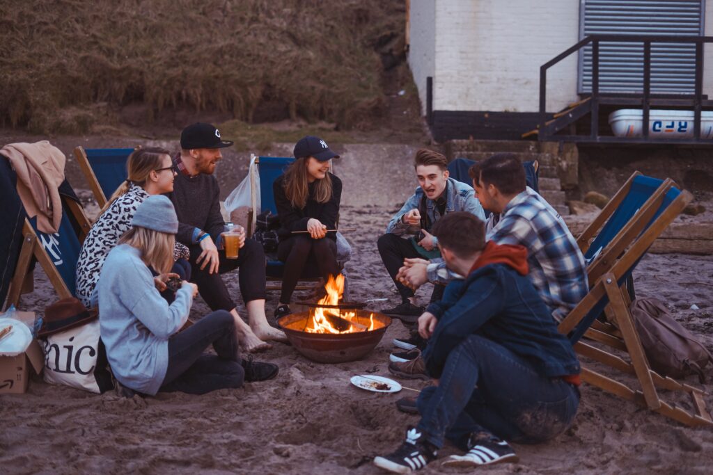 Friends sitting around a campfire on a friends camping trip