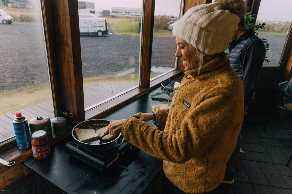 Cooking toast in Iceland after renting a campervan