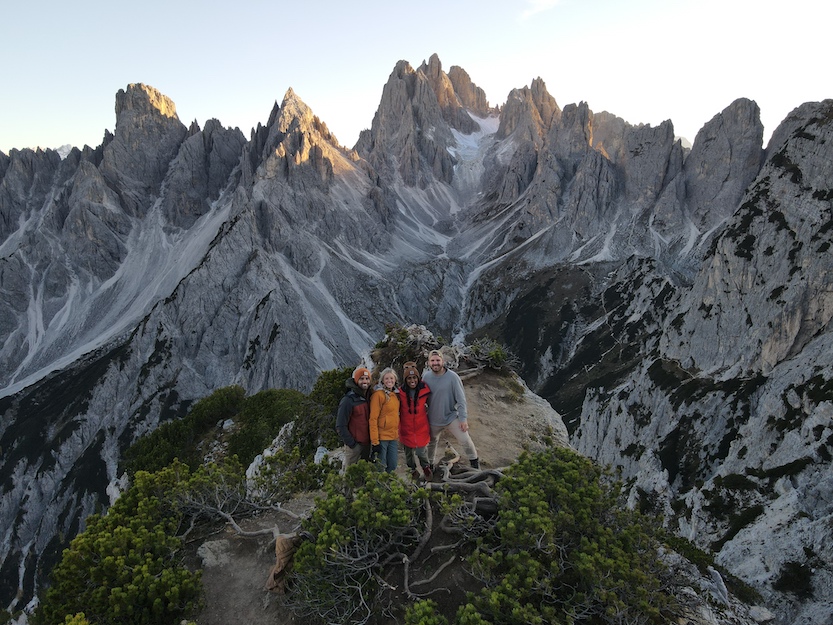Four friends at the top of Cadini di Misurina hike in the Dolomites, Italy.