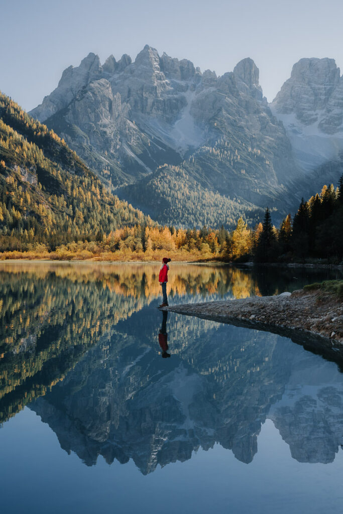 Chelsey Explores standing at the edge of the water at Lago di Landro