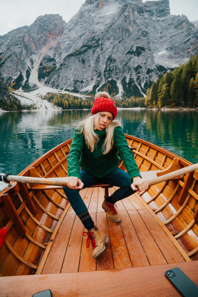 Chelsey Explores rowing a boat on Lago di Braies in the Dolomites