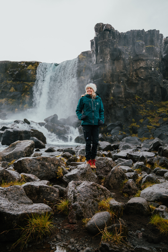 Girl in front of waterfall at Thingvellir National Park in Iceland