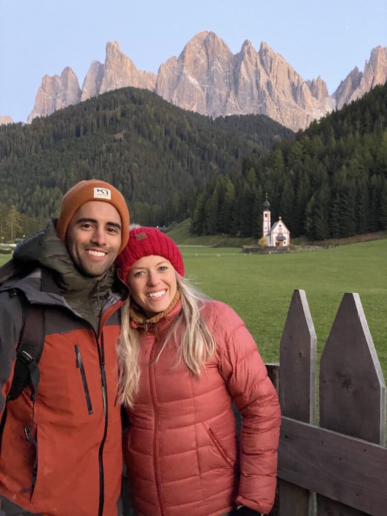 Couple standing in front of the church of Santa Magdalena at sunset