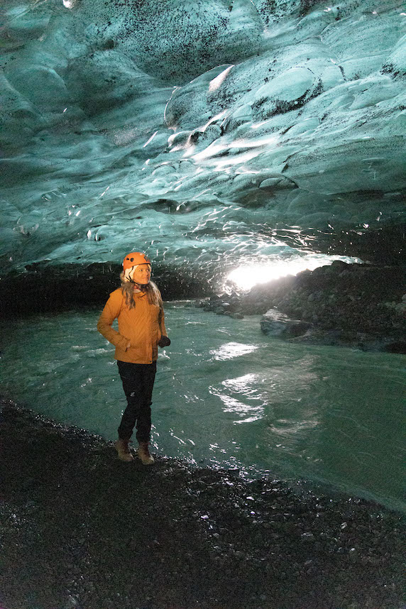 Girl standing in an ice cave in Iceland