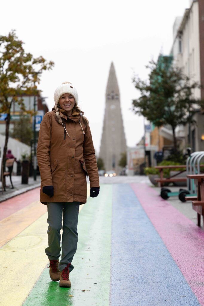 Girl on rainbow road in Iceland