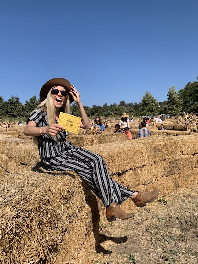 Chelsey sitting on a hay stack at Bates nut Farm