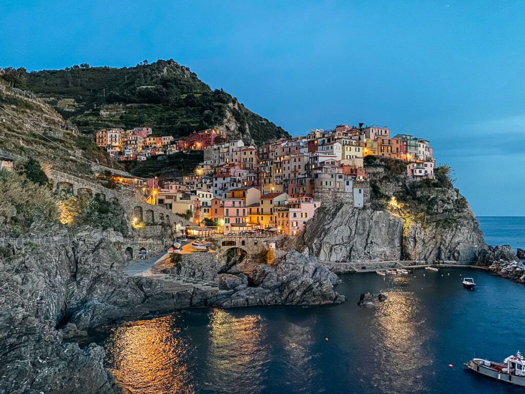 Nighttime views of the village Manarola in Cinque Terre which is one of the cities you can visit as part of your one day itinerary