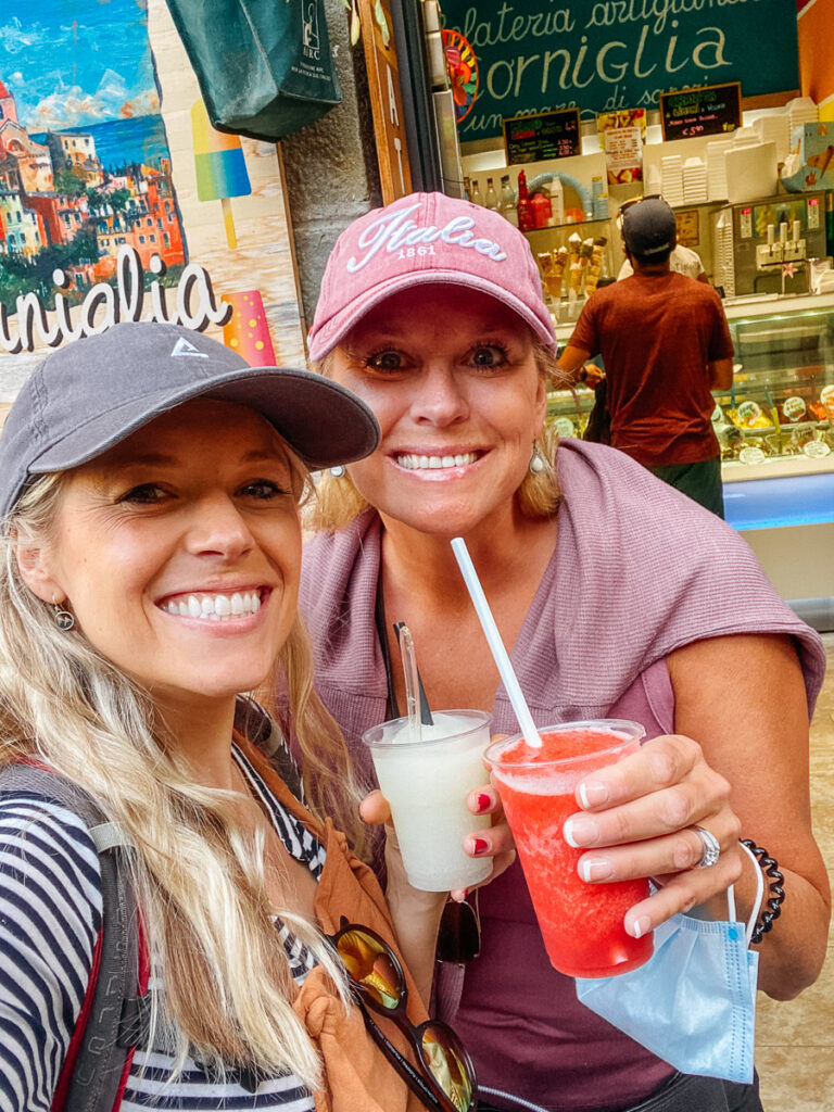 Chelsey Explores and her mom drinking lemonade slushies in the Cinque Terre town of Corniglia