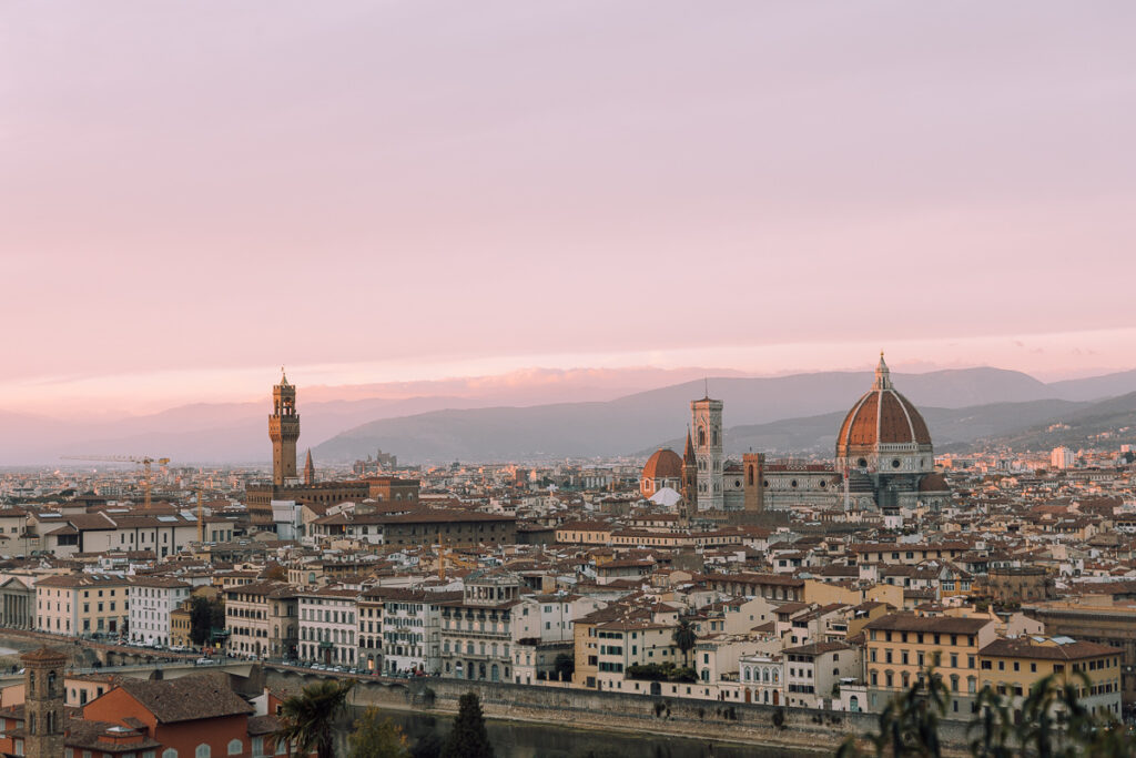 Sunset views of the city of Florence from Piazzale Michelangelo which is a must add stop to your Tuscany road trip