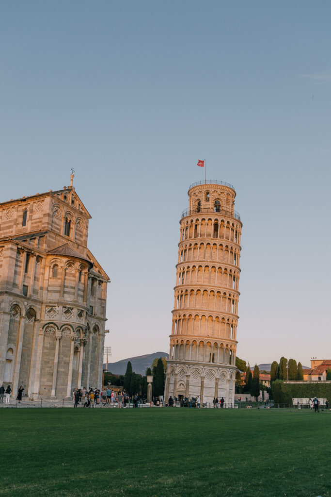 The leaning tower of Pisa and its surrounding buildings at sunset