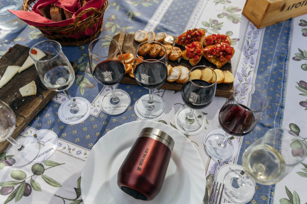 Beautiful setup of wine and cheese at a Tuscany winery which is a stop to make on your road trip