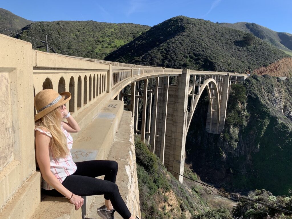 Girls sitting on the Bixby Bridge in Big Sur