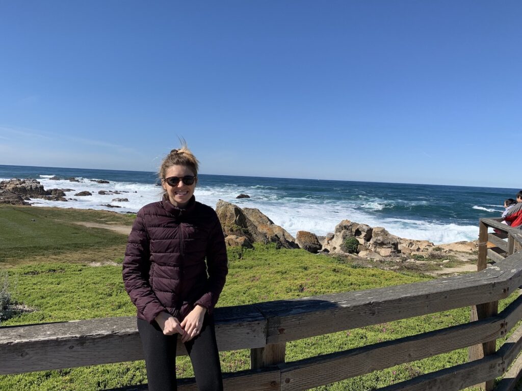 Girl at Pebble Beach along her Highway 1 road trip 