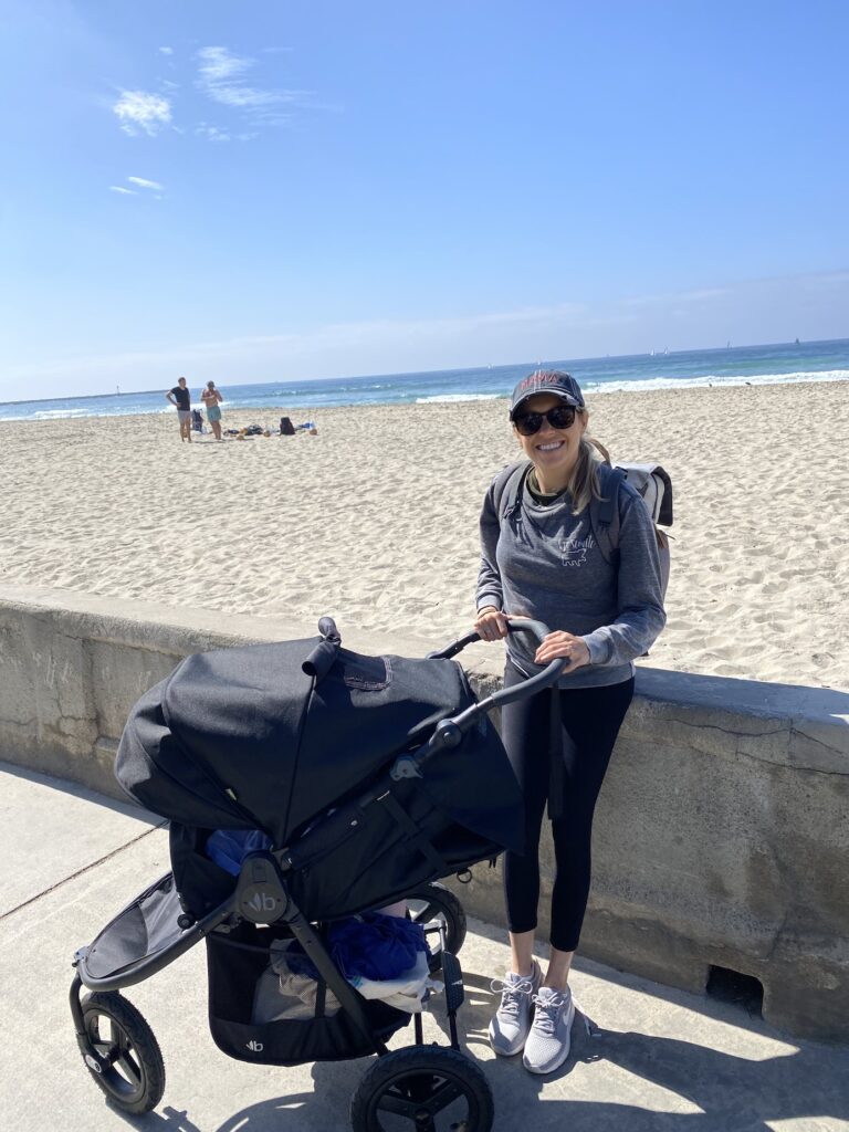 Girl at Mission beach boardwalk with her stroller