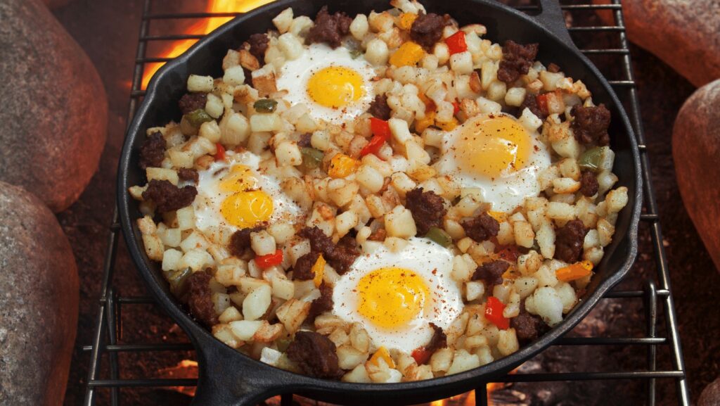Campfire hash cooking over campfire as an easy camping breakfast meal