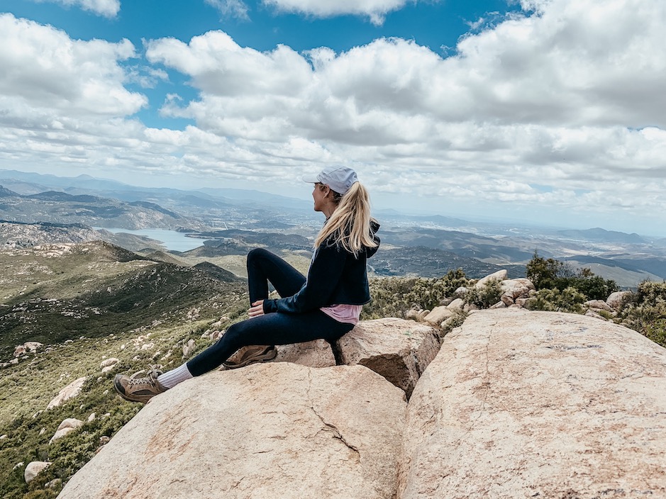 Chelsey sitting on top of Iron Mountain in San Diego