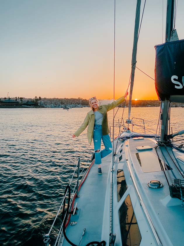 Girl on a sailboat with the sunset