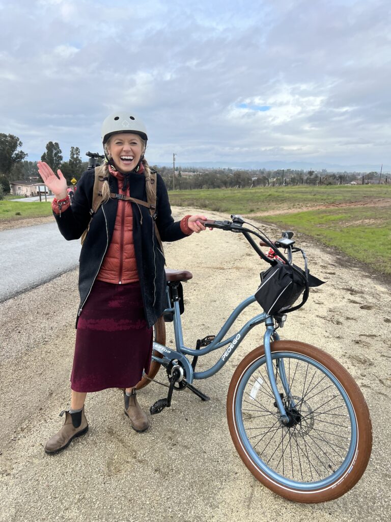 Girl standing with her e-bike from Pedego