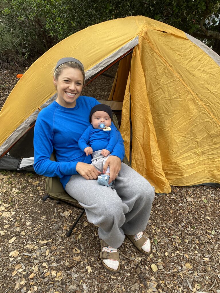 mom and son sitting in chair at campsite