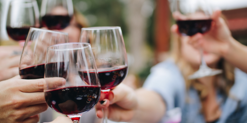 friends cheersing and drinking wine