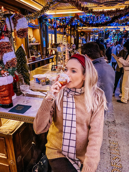 Girl drinking a cocktail at the Polite Provisiions Christmas bar in San Diego